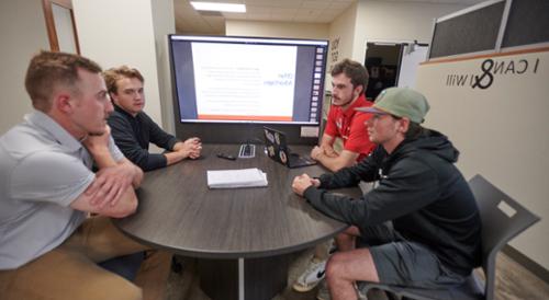 Four students participate in a study group